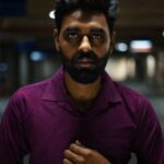 Indoor portrait of a bearded man in a dimly lit setting in Chandigarh.